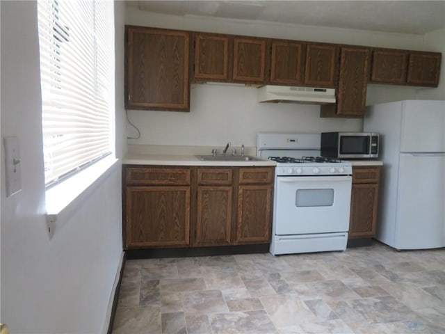 7005 Mckinley Ct, Clairton, PA 15025 - kitchen featuring white appliances, under cabinet range hood, light countertops, and stone finish flooring