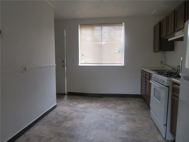 7005 Mckinley Ct, Clairton, PA 15025 - kitchen featuring white appliances, stone finish flooring, light countertops, and under cabinet range hood