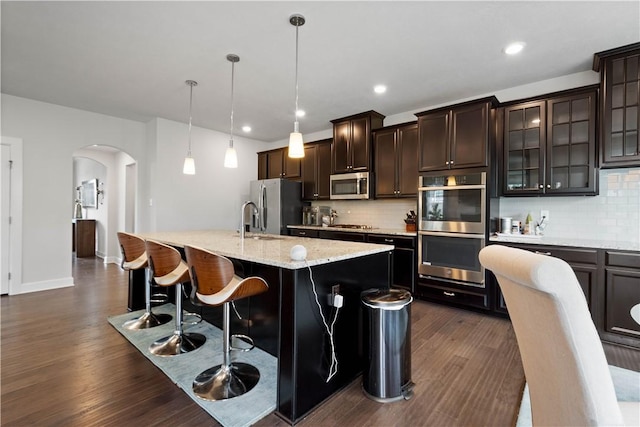 1761 Stevensan Dr, Franklin Park, PA 15143 - kitchen with appliances with stainless steel finishes, arched walkways, dark wood finished floors, backsplash, and recessed lighting