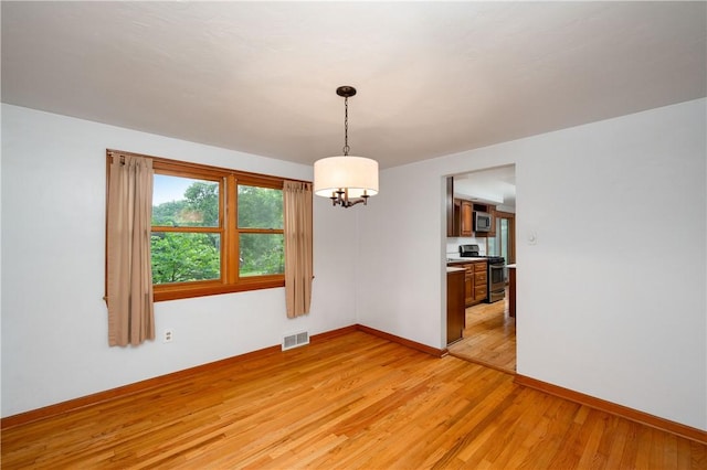 131 Windgate Dr, Marshall, PA 15090 - empty room with light wood finished floors and a chandelier