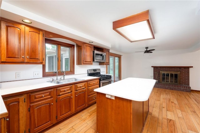 131 Windgate Dr, Marshall, PA 15090 - kitchen with stainless steel appliances, brown cabinetry, a center island, light countertops, and light wood-style floors