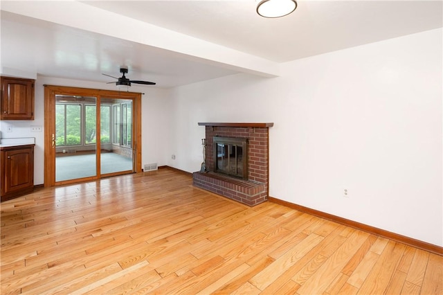 131 Windgate Dr, Marshall, PA 15090 - unfurnished living room featuring light wood-style flooring, a ceiling fan, and a brick fireplace
