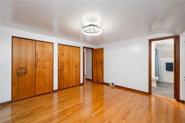 131 Windgate Dr, Marshall, PA 15090 - unfurnished bedroom with two closets, light wood-type flooring, ensuite bath, and vaulted ceiling