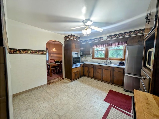 373 Pittsburgh St, Derry Twp, PA 15671 - kitchen with appliances with stainless steel finishes, light countertops, arched walkways, light floors, and ceiling fan