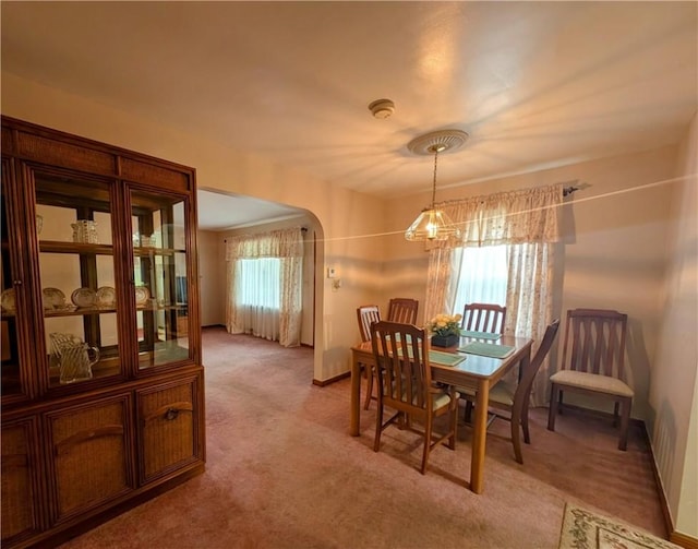 373 Pittsburgh St, Derry Twp, PA 15671 - dining area featuring arched walkways, light colored carpet, and a chandelier