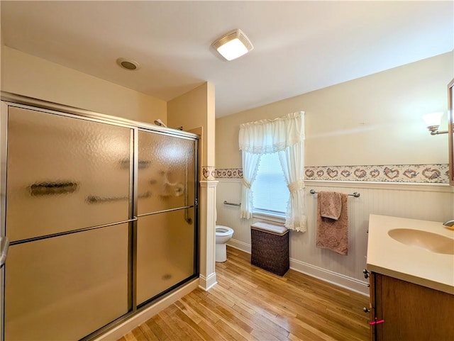 373 Pittsburgh St, Derry Twp, PA 15671 - bathroom featuring wainscoting, wood finished floors, vanity, and a shower stall