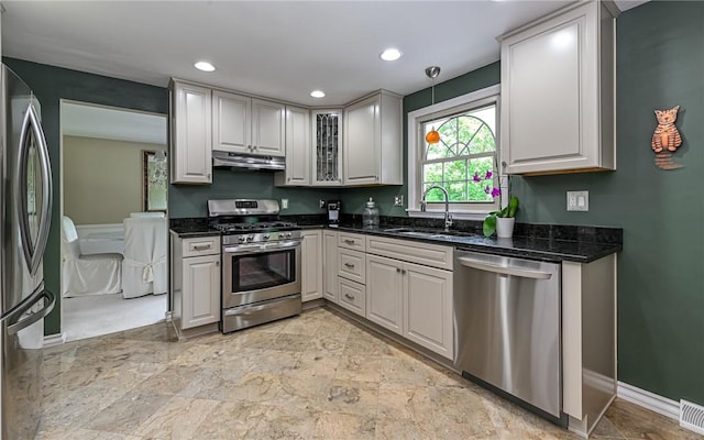 2276 Rochester Rd, Franklin Park, PA 15237 - kitchen featuring appliances with stainless steel finishes, under cabinet range hood, glass insert cabinets, recessed lighting, and dark stone counters