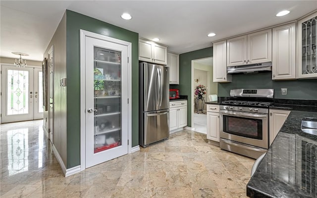 2276 Rochester Rd, Franklin Park, PA 15237 - kitchen with stainless steel appliances, under cabinet range hood, dark stone counters, glass insert cabinets, and recessed lighting