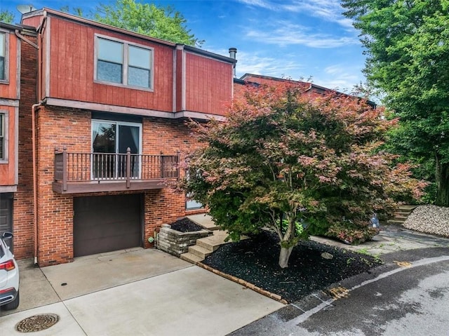 226 Glen Spring Cir, North Strabane, PA 15317 - view of front of house featuring driveway, a garage, brick siding, and a balcony