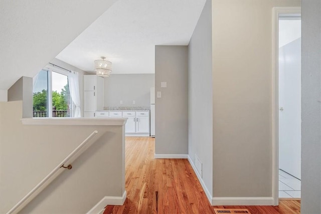 226 Glen Spring Cir, North Strabane, PA 15317 - hallway with an upstairs landing and light wood-style floors