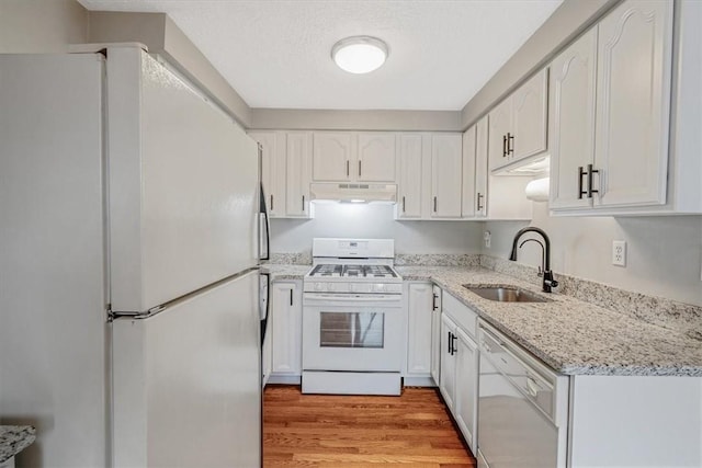 226 Glen Spring Cir, North Strabane, PA 15317 - kitchen with white appliances, under cabinet range hood, light wood finished floors, and white cabinetry