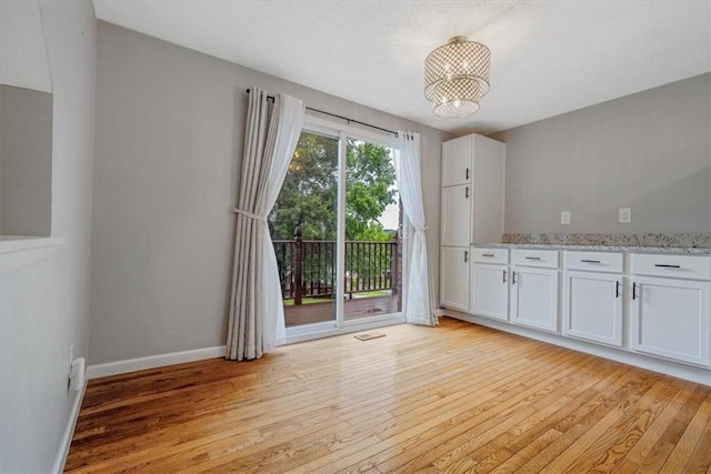 226 Glen Spring Cir, North Strabane, PA 15317 - unfurnished dining area with light wood-style flooring and a chandelier