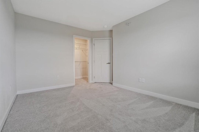 2058 Cade Dr, Potter Twp, PA 15061 - unfurnished bedroom featuring light carpet, a walk in closet, and a closet