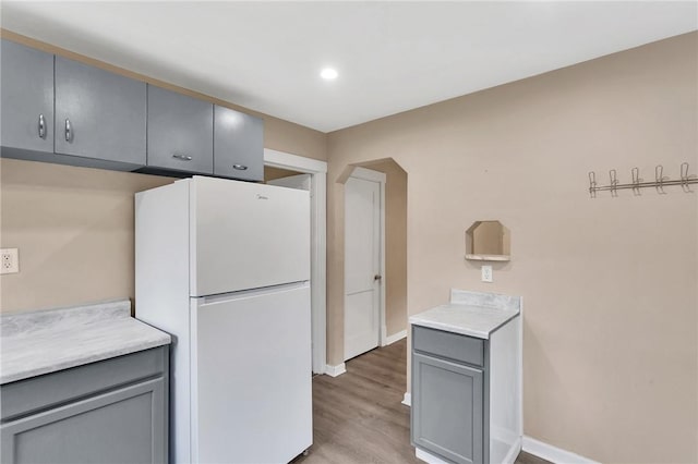 1048 Unity Center Rd, Plum Boro, PA 15239 - kitchen featuring freestanding refrigerator, gray cabinets, light wood-style flooring, light countertops, and recessed lighting