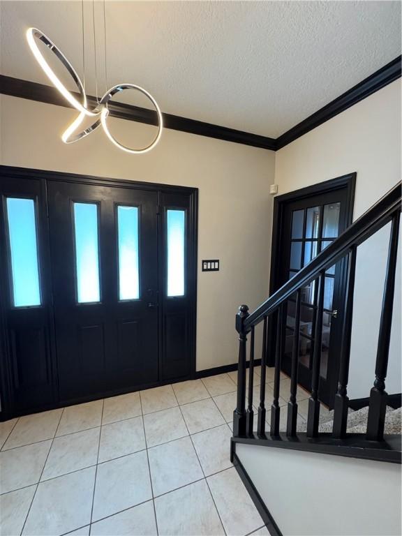 91 Celtic Ash Ct, Cranberry Twp, PA 16066 - foyer entrance featuring stairs, a textured ceiling, light tile patterned flooring, and ornamental molding