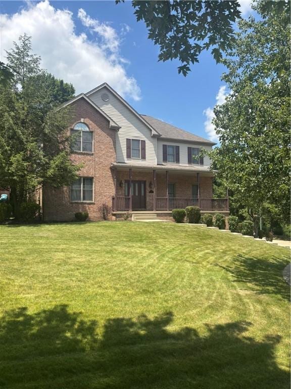 91 Celtic Ash Ct, Cranberry Twp, PA 16066 - view of front of house featuring a porch, a front lawn, and brick siding