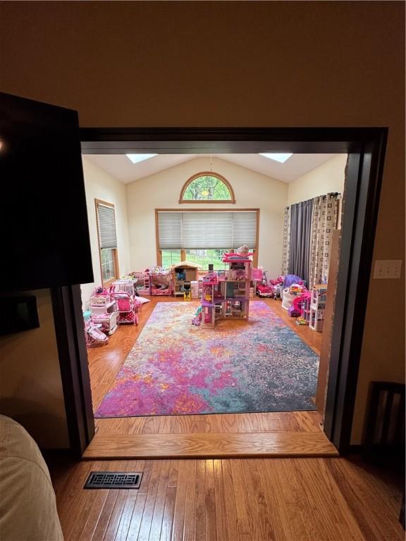 91 Celtic Ash Ct, Cranberry Twp, PA 16066 - game room featuring lofted ceiling, wood-type flooring, and a skylight