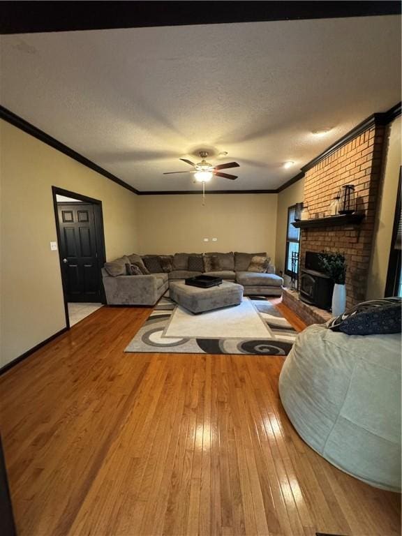 91 Celtic Ash Ct, Cranberry Twp, PA 16066 - living area with crown molding, hardwood / wood-style flooring, ceiling fan, a brick fireplace, and a textured ceiling