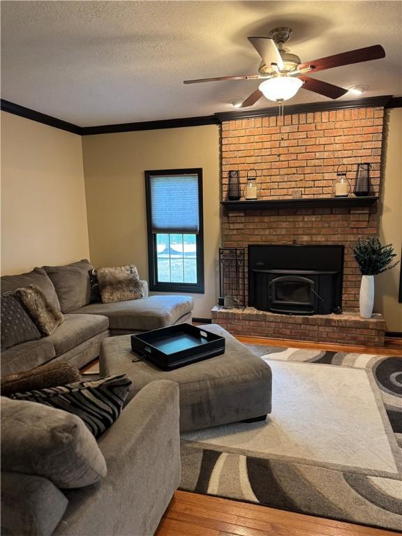 91 Celtic Ash Ct, Cranberry Twp, PA 16066 - living room with hardwood / wood-style flooring, crown molding, a ceiling fan, and a textured ceiling