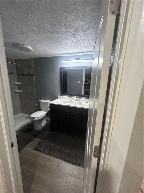 2814 Eccles St, South Side, PA 15210 - bathroom featuring vanity, a shower stall, and a textured ceiling