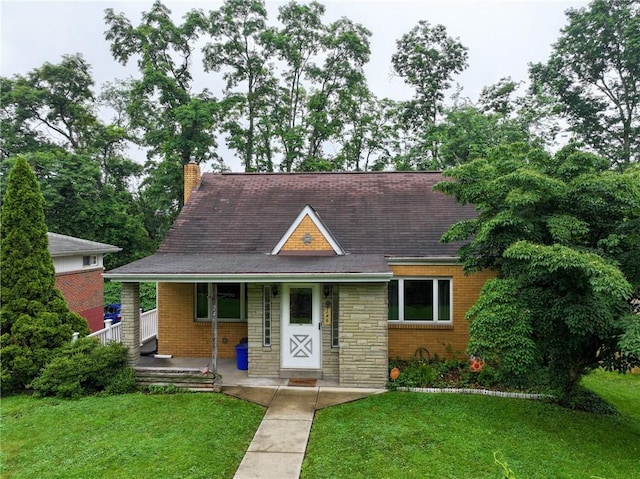246 Maple Dr, Monroeville, PA 15146 - view of front of house featuring a front yard, a porch, a chimney, and stone siding