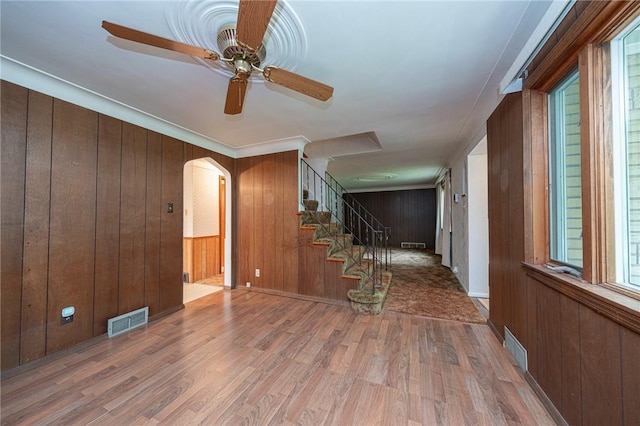 246 Maple Dr, Monroeville, PA 15146 - foyer entrance with wood finished floors, wooden walls, ceiling fan, arched walkways, and stairway