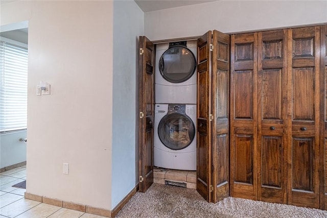 315 Pennsylvania Ave, Plum Boro, PA 15147 - washroom with stacked washer and clothes dryer, light tile patterned flooring, and plenty of natural light
