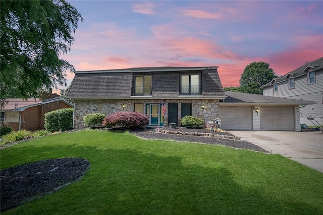 315 Pennsylvania Ave, Plum Boro, PA 15147 - front facade featuring stone siding, driveway, a garage, and a lawn