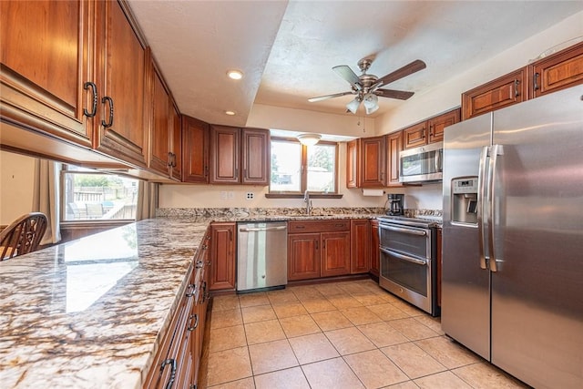 315 Pennsylvania Ave, Plum Boro, PA 15147 - kitchen featuring appliances with stainless steel finishes, healthy amount of natural light, a ceiling fan, brown cabinets, and recessed lighting