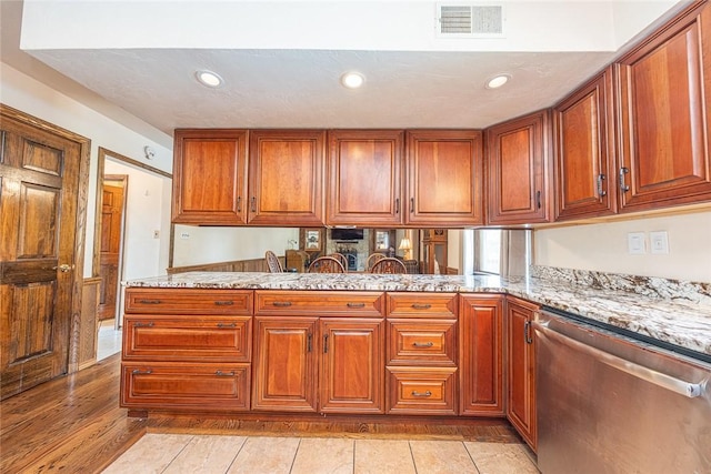 315 Pennsylvania Ave, Plum Boro, PA 15147 - kitchen with dishwasher, brown cabinets, recessed lighting, a peninsula, and light stone counters
