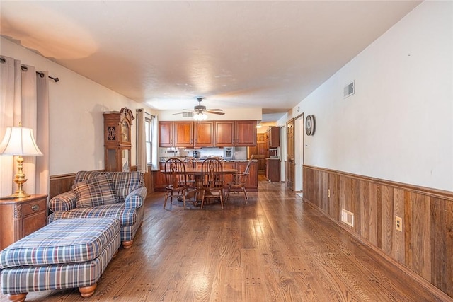 315 Pennsylvania Ave, Plum Boro, PA 15147 - living room with wainscoting, wood finished floors, wooden walls, and ceiling fan