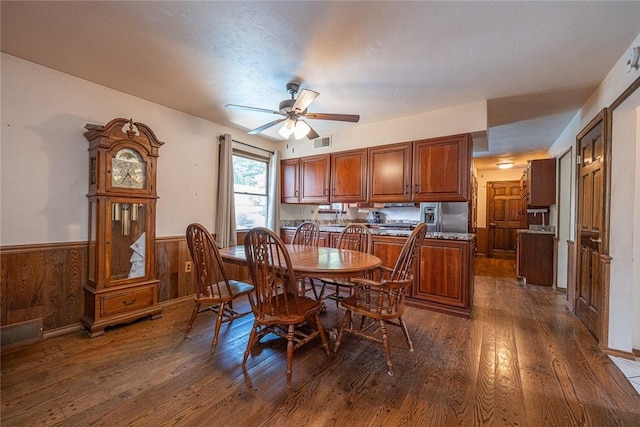 315 Pennsylvania Ave, Plum Boro, PA 15147 - dining room featuring dark wood-style flooring, a wainscoted wall, a ceiling fan, and wood walls