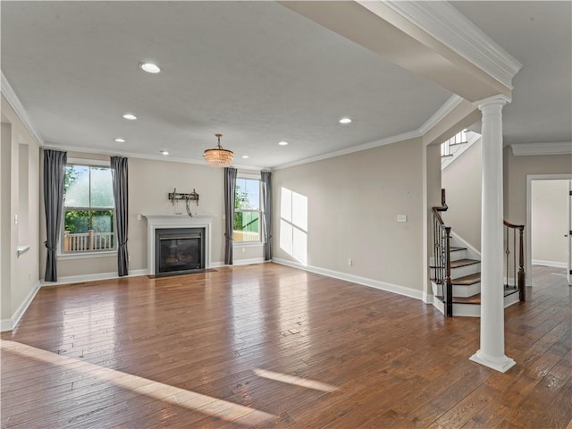 4402 Walnut Ridge Cir, South Fayette, PA 15057 - unfurnished living room with crown molding, hardwood / wood-style floors, ornate columns, a glass covered fireplace, and recessed lighting