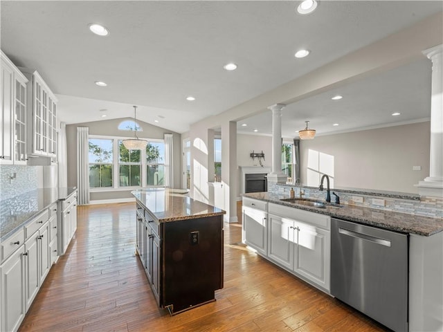 4402 Walnut Ridge Cir, South Fayette, PA 15057 - kitchen with stainless steel dishwasher, ornate columns, a kitchen island with sink, white cabinets, and lofted ceiling
