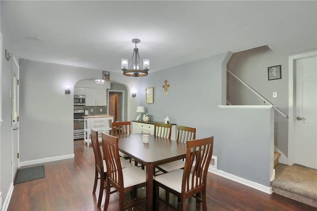 866 Connolly Ave, South Park, PA 15236 - dining room with dark wood-type flooring, arched walkways, stairs, and a chandelier