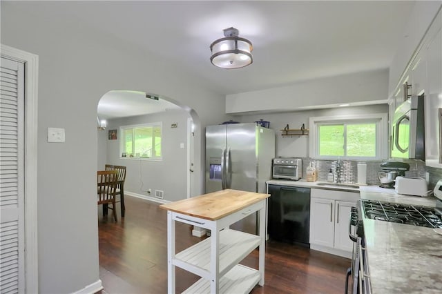 866 Connolly Ave, South Park, PA 15236 - kitchen featuring stainless steel appliances, arched walkways, tasteful backsplash, and white cabinets