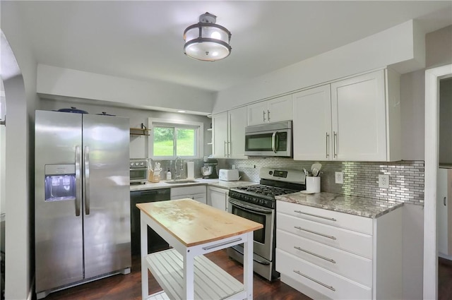 866 Connolly Ave, South Park, PA 15236 - kitchen with stainless steel appliances, white cabinets, backsplash, and light stone counters