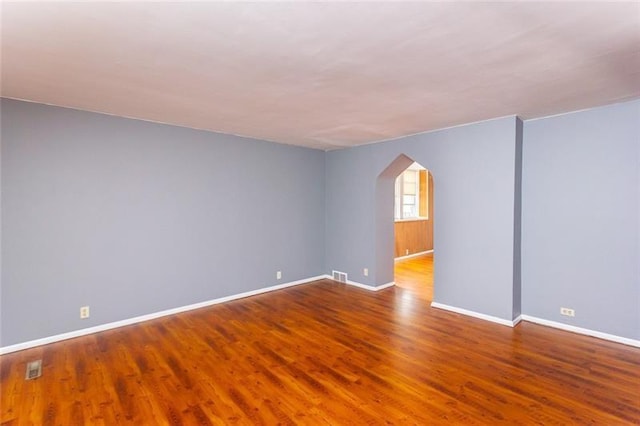 650 Loretta St, Greenfield, PA 15217 - empty room with arched walkways and wood finished floors