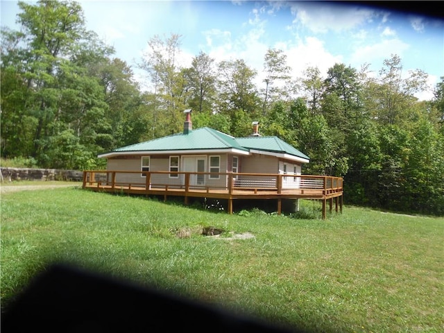 1276 Glades Pike, Somerset, PA 15501 - back of property featuring a yard, a chimney, a deck, a metal roof, and view of wooded area
