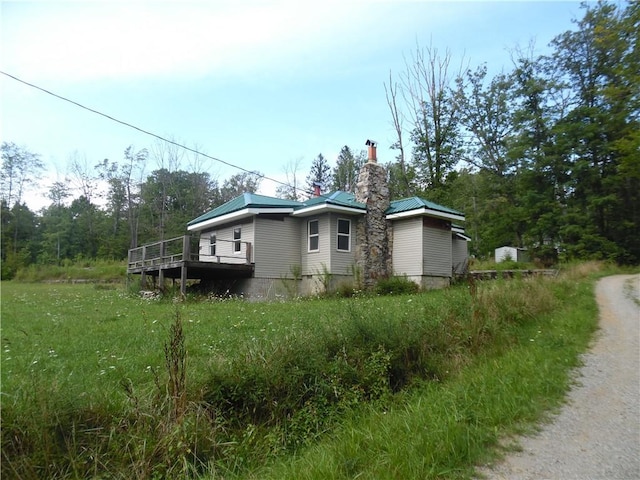 1276 Glades Pike, Somerset, PA 15501 - view of side of home with a chimney, a wooden deck, and a metal roof