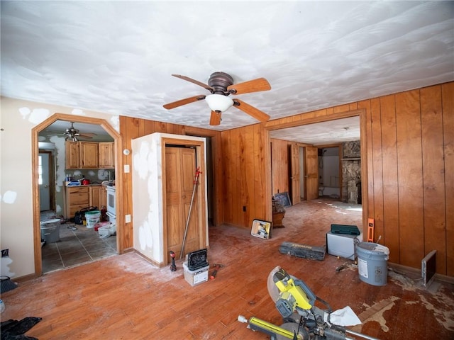 1276 Glades Pike, Somerset, PA 15501 - unfurnished living room with ceiling fan, wooden walls, and wood finished floors