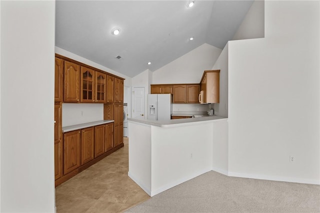 1901 Golf Course Dr, South Strabane, PA 15301 - kitchen featuring white fridge with ice dispenser, light countertops, a peninsula, brown cabinetry, and glass insert cabinets