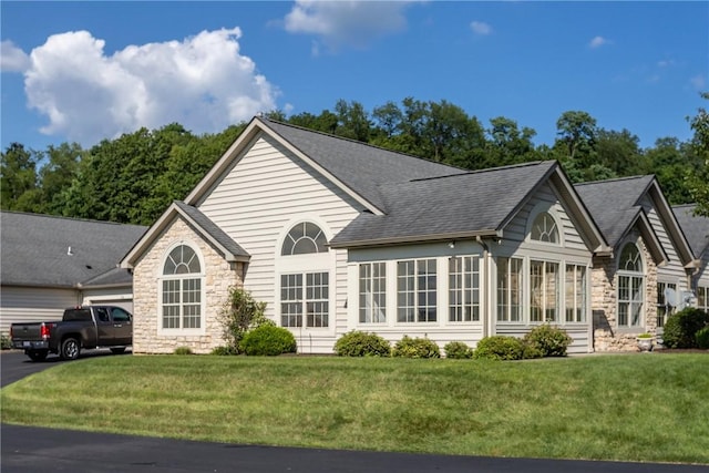 1901 Golf Course Dr, South Strabane, PA 15301 - back of property with stone siding, a yard, a garage, and driveway