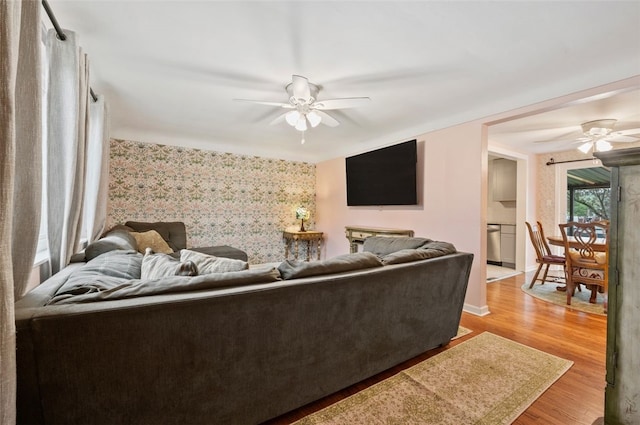 235 Ruth St, Plum Boro, PA 15239 - living area featuring wallpapered walls, ceiling fan, and wood finished floors