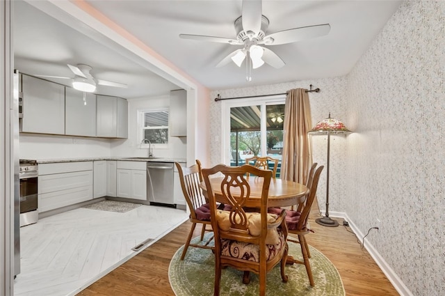 235 Ruth St, Plum Boro, PA 15239 - dining room featuring a ceiling fan, wallpapered walls, and light wood-style flooring