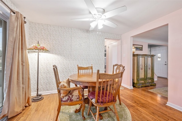 235 Ruth St, Plum Boro, PA 15239 - dining area with wallpapered walls, wood finished floors, and a ceiling fan