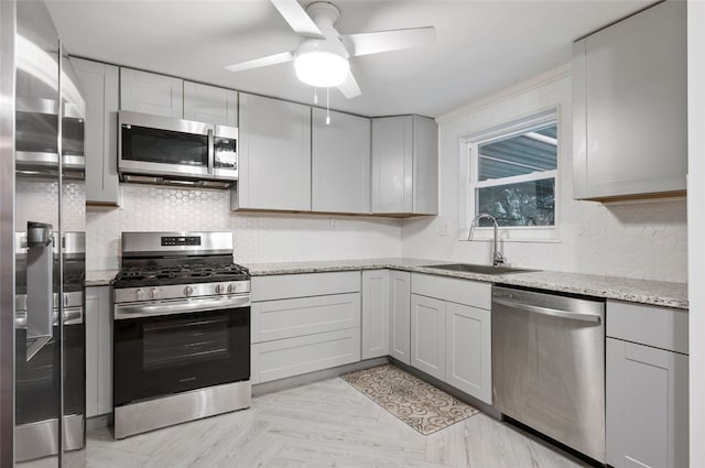 235 Ruth St, Plum Boro, PA 15239 - kitchen with appliances with stainless steel finishes, a ceiling fan, backsplash, and light stone countertops