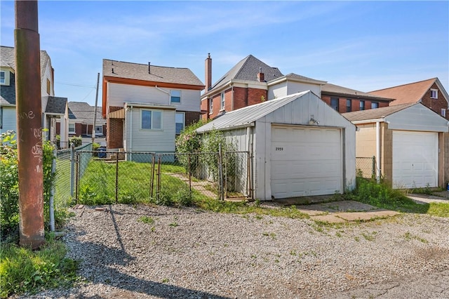 2959 Churchview Ave, Baldwin Boro, PA 15227 - rear view of house featuring board and batten siding, an outdoor structure, a gate, and a detached garage