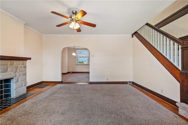 2959 Churchview Ave, Baldwin Boro, PA 15227 - unfurnished living room with arched walkways, crown molding, ceiling fan, a fireplace with flush hearth, and stairs