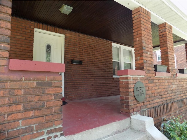 437 Green St, Munhall, PA 15120 - property entrance featuring brick siding and covered porch